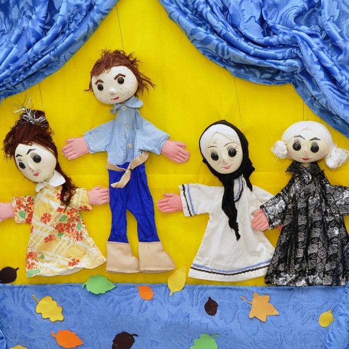 Various puppets on stage.