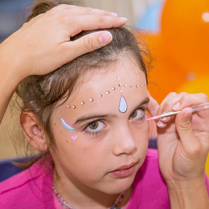 Girl having a face painting.
