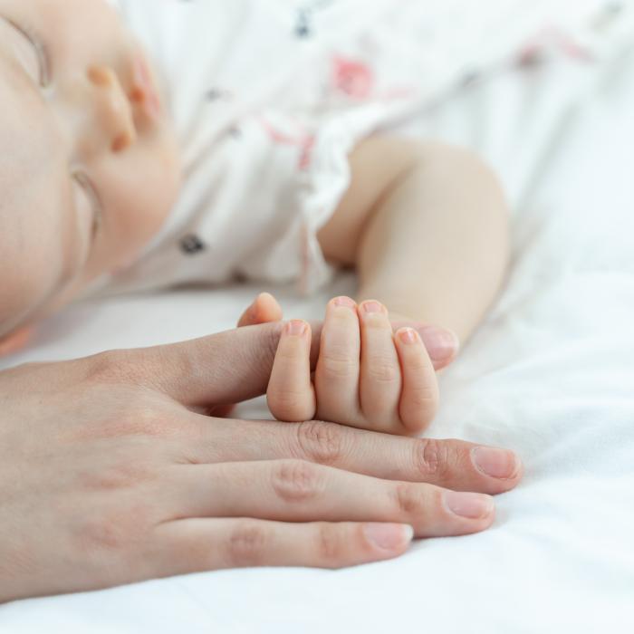 baby sleeping grabbing her mother s finger2