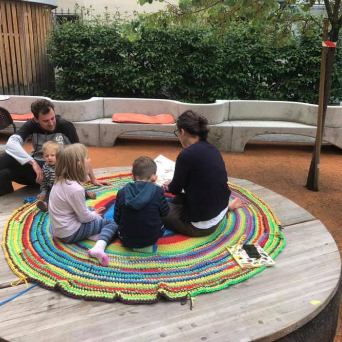 Children, sitting on the floor, listening to a fairy tale.