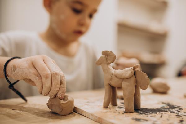cute boy forming toys from clay2