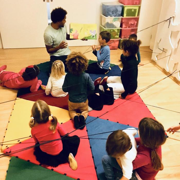 Children playing with their teacher.