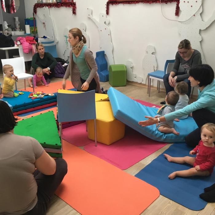 Mothers listening carefully to the instructions, and babies practice.