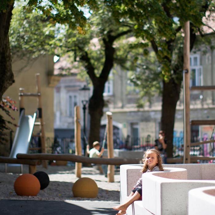 Photograph of the Mala ulica outdoor playground, lit by the sun.