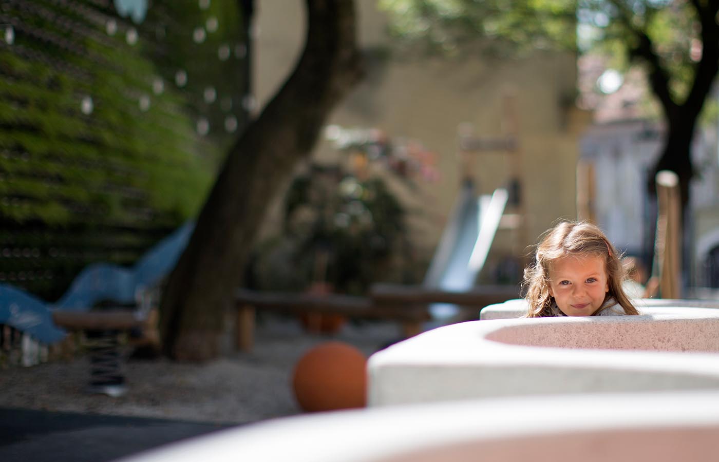 Cheerful girl on the outdoor playground.