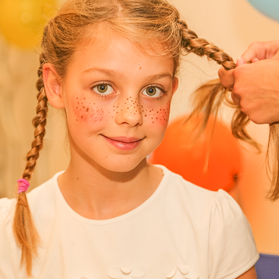 Deklica, preoblečena v Piko Nogavičko.