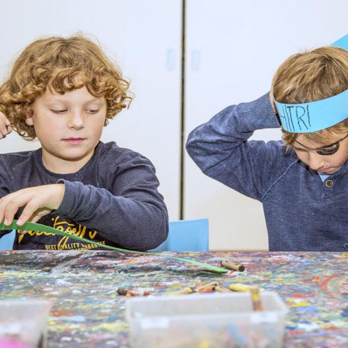 Two little Indian boys having fun making gadgets for the party.