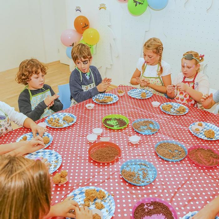 Children making sweets on the table.