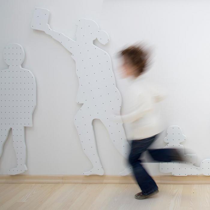 Cheerful kid running down the interiror playroom of the Mala ulica.